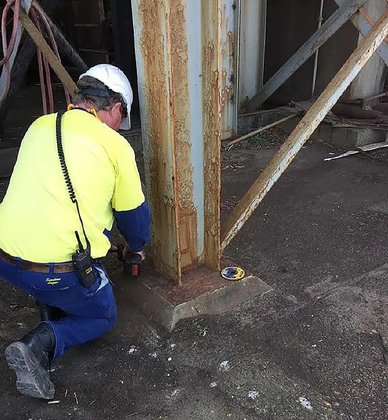 Base of structural steel column prepared by hand tool