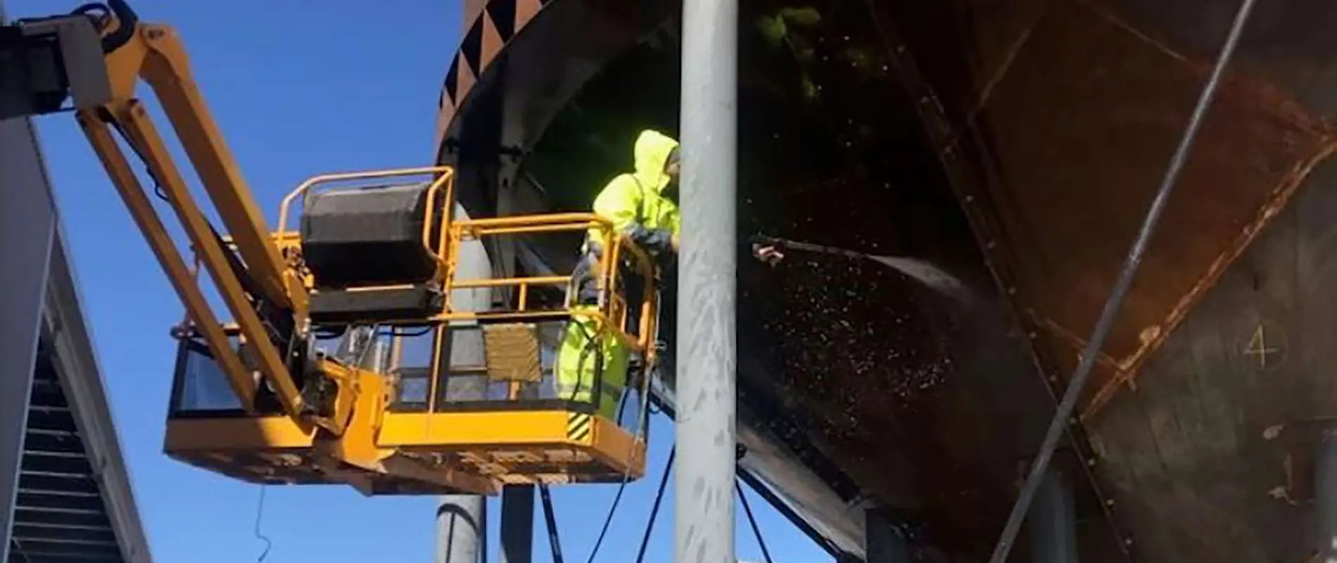 Water tank surface preparation using pressure wash